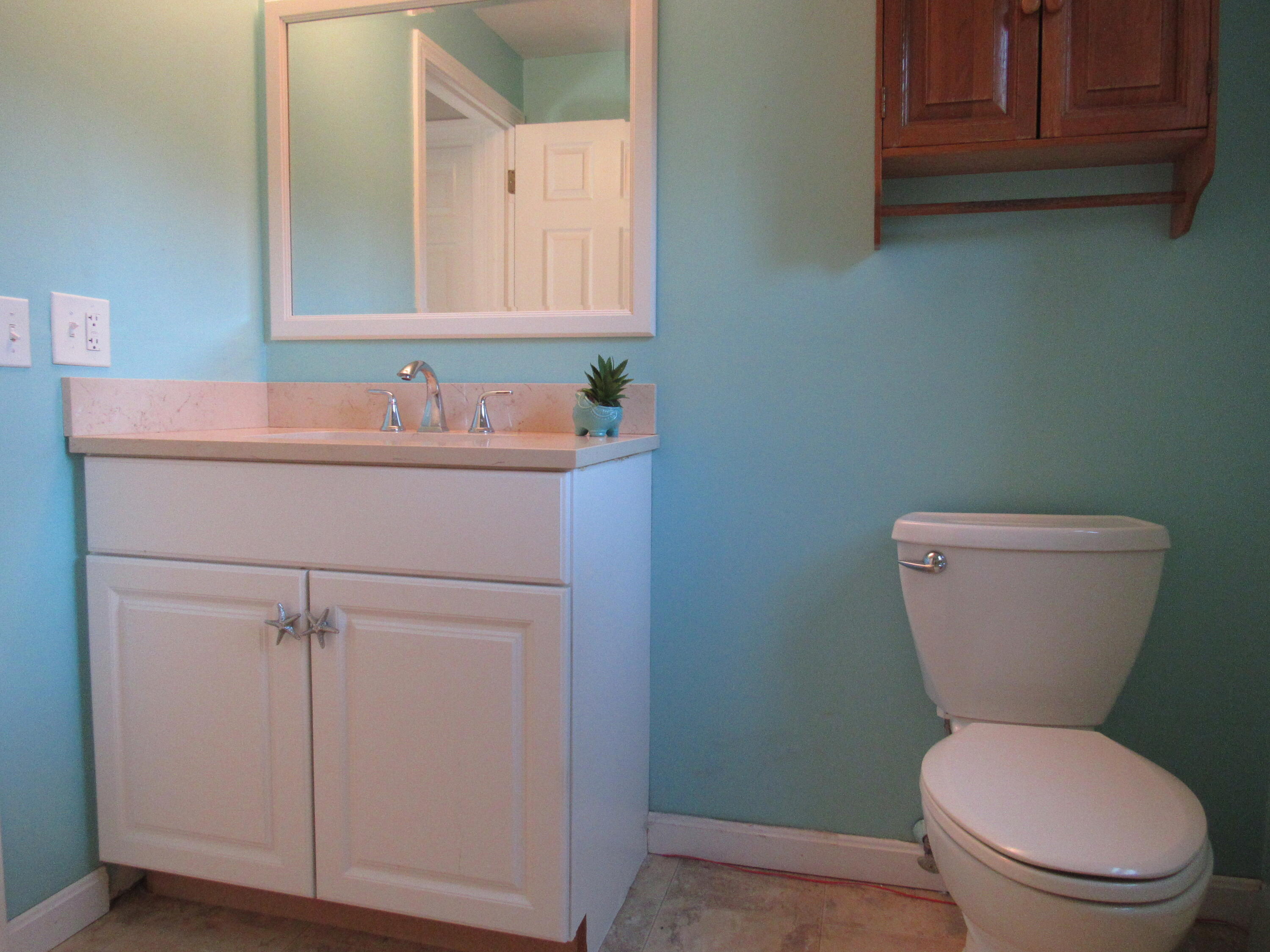 249 Ames Way Centerville, MA 02632 - Photo 37 of 41 a bathroom with a toilet sink and mirror