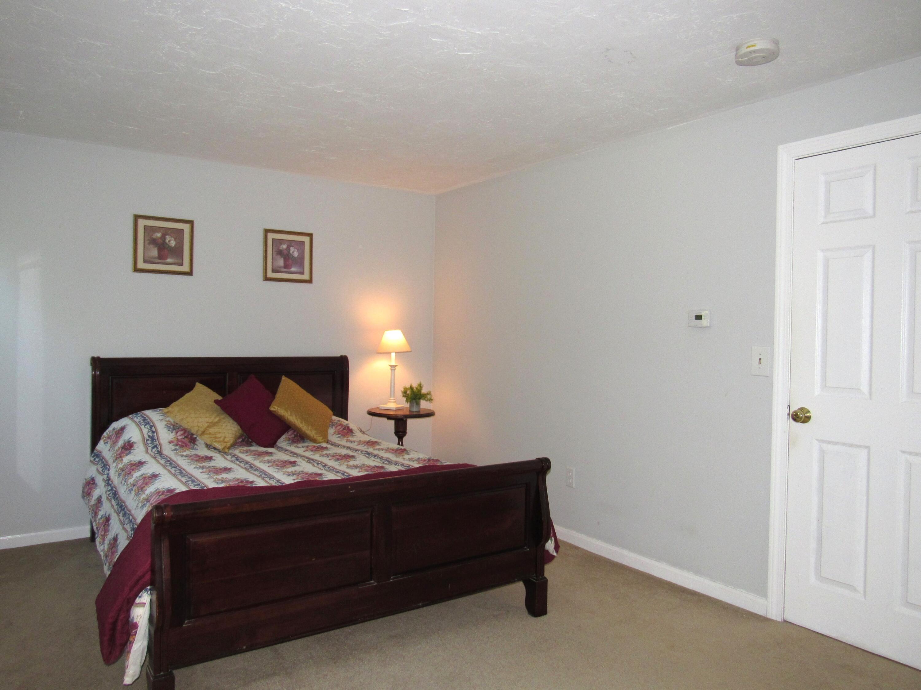 249 Ames Way Centerville, MA 02632 - Photo 39 of 41 a bedroom with a bed and a lamp