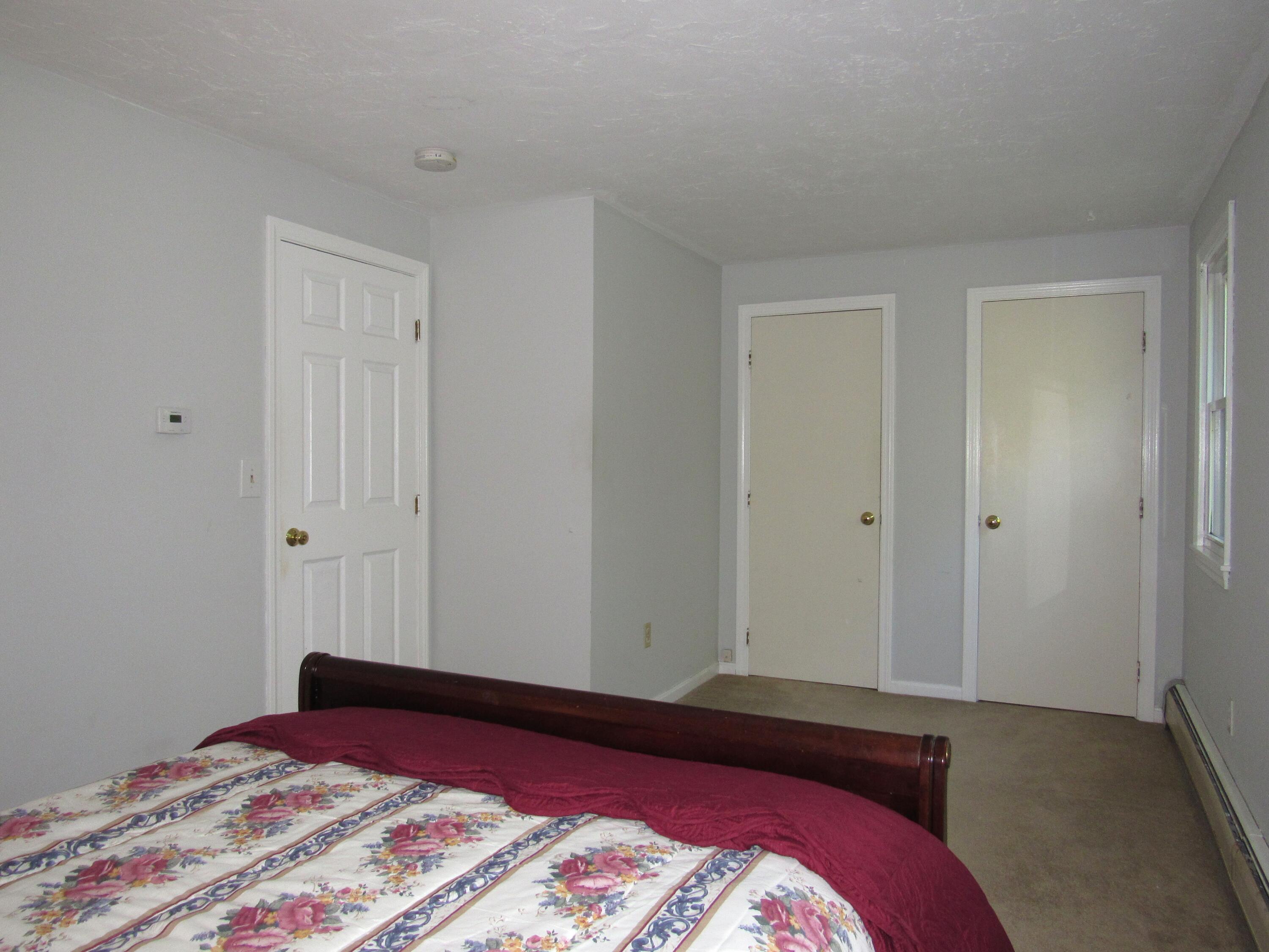 249 Ames Way Centerville, MA 02632 - Photo 40 of 41 a bedroom with a bed and a lamp