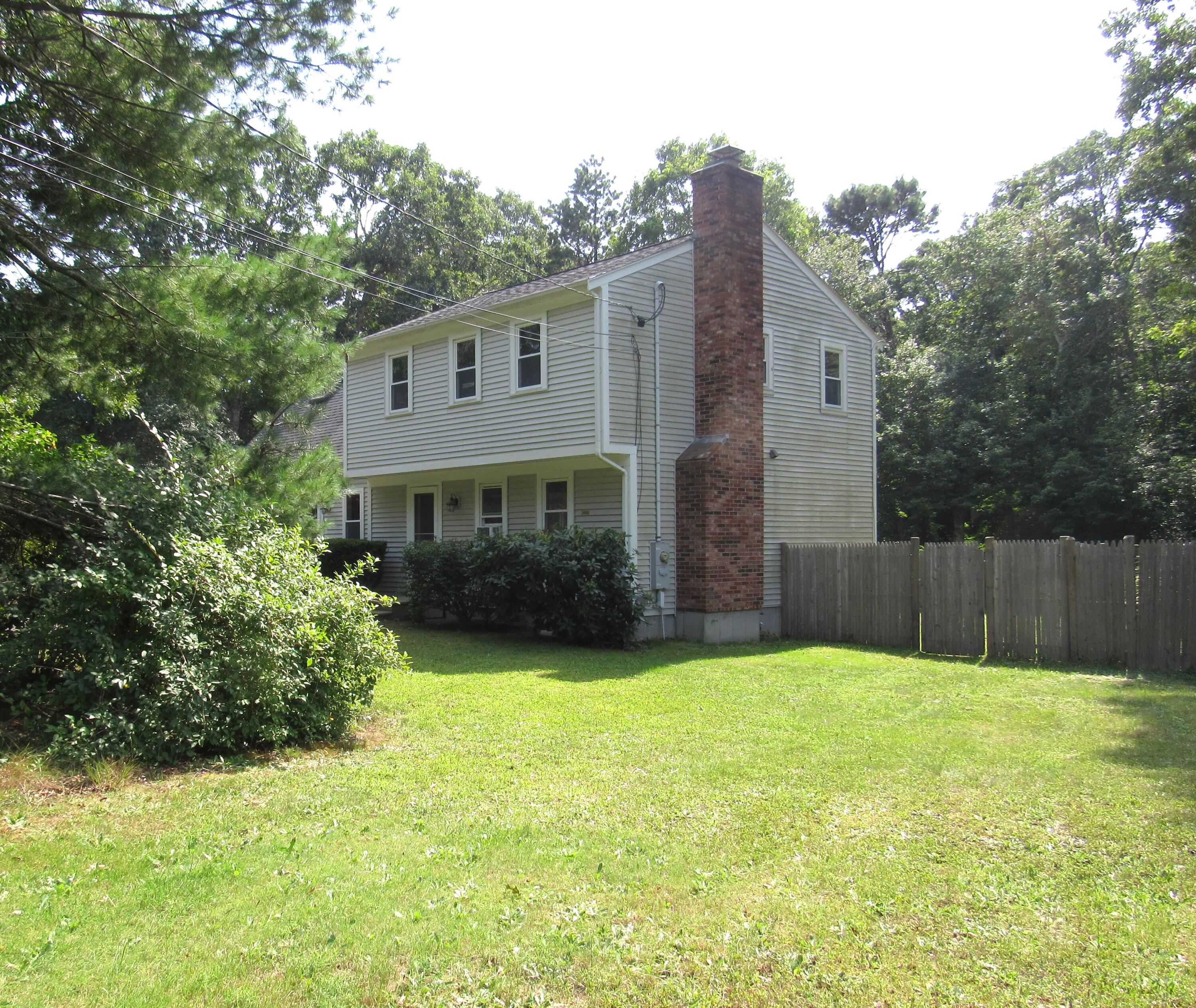 249 Ames Way Centerville, MA 02632 - Photo 4 of 41 a view of a house with a yard and sitting area