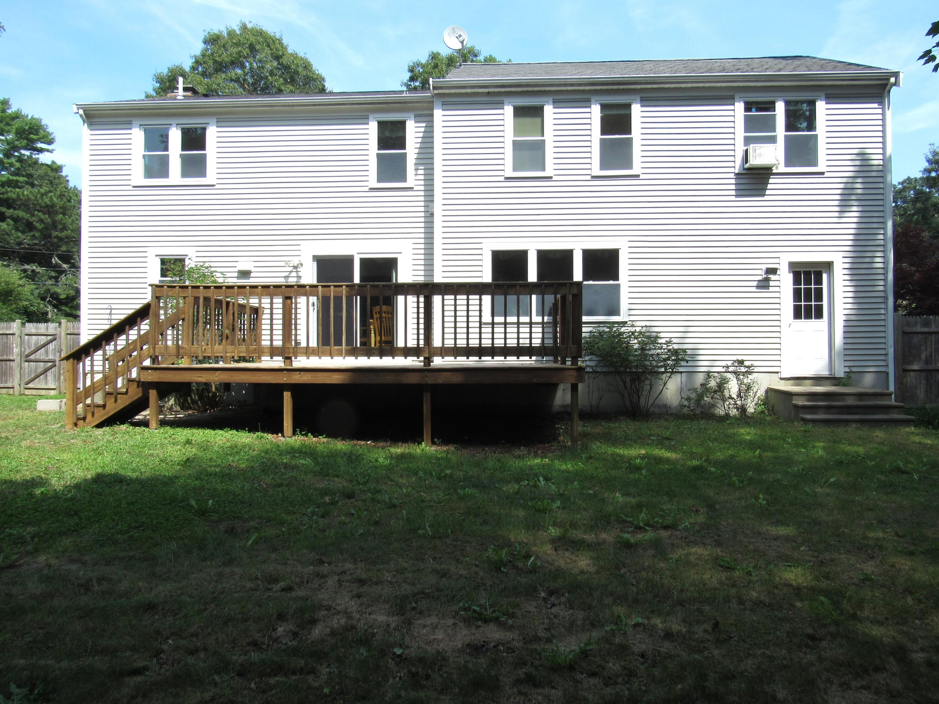 249 Ames Way Centerville, MA 02632 - Photo 5 of 41 a view of a house with backyard and porch