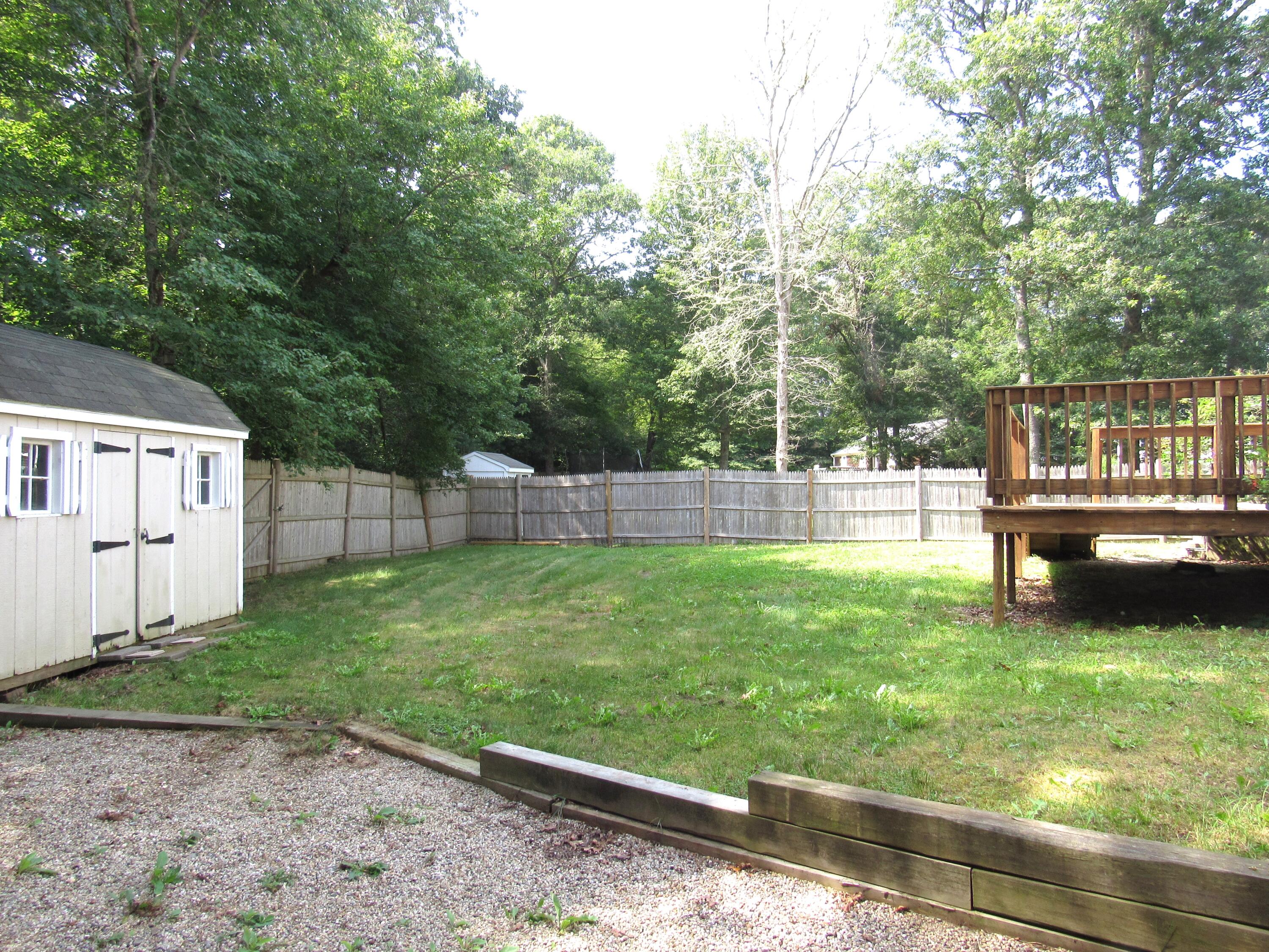249 Ames Way Centerville, MA 02632 - Photo 7 of 41 a view of a backyard with a garden