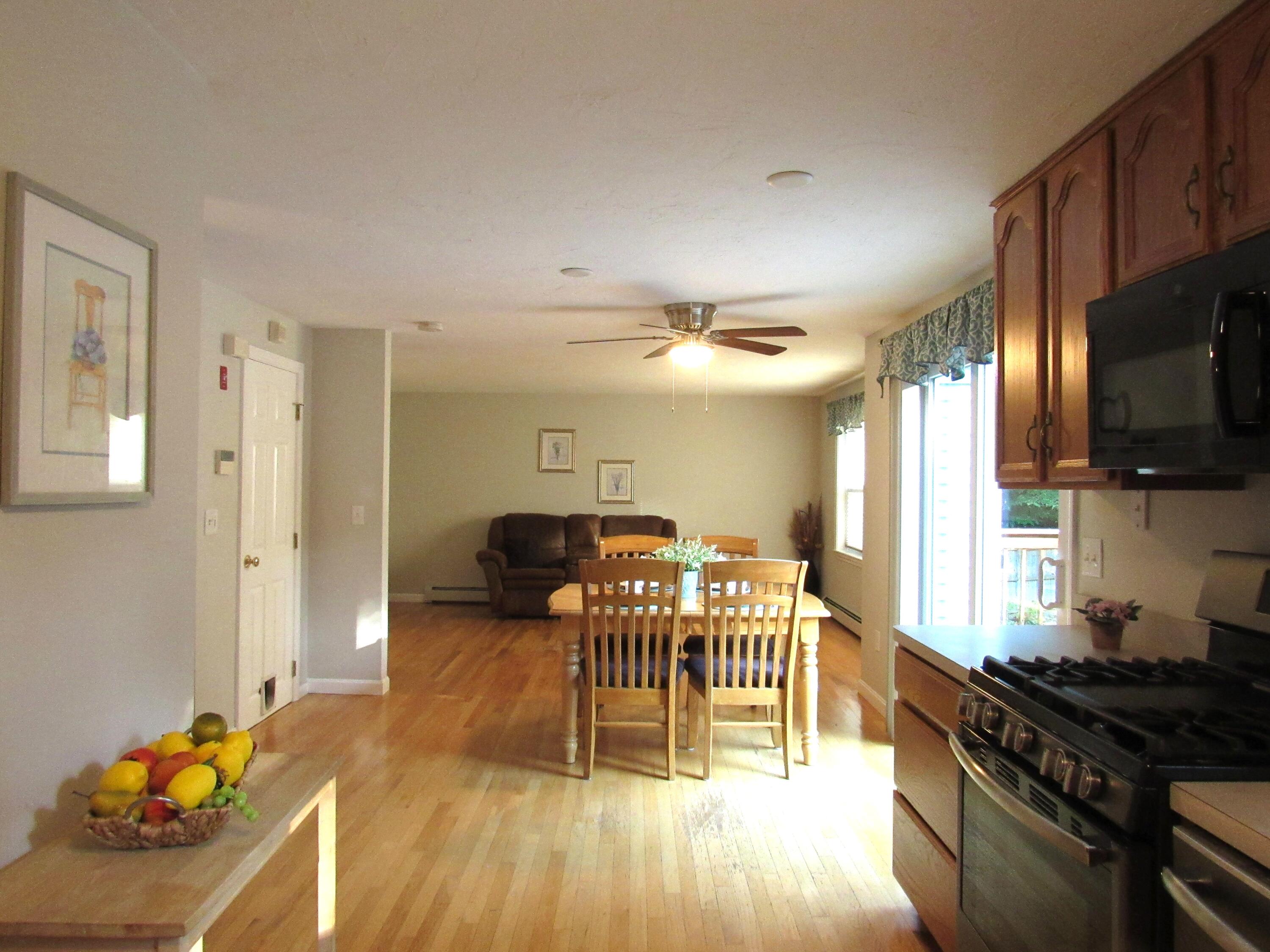 249 Ames Way Centerville, MA 02632 - Photo 9 of 41 a dining room with furniture and a kitchen view