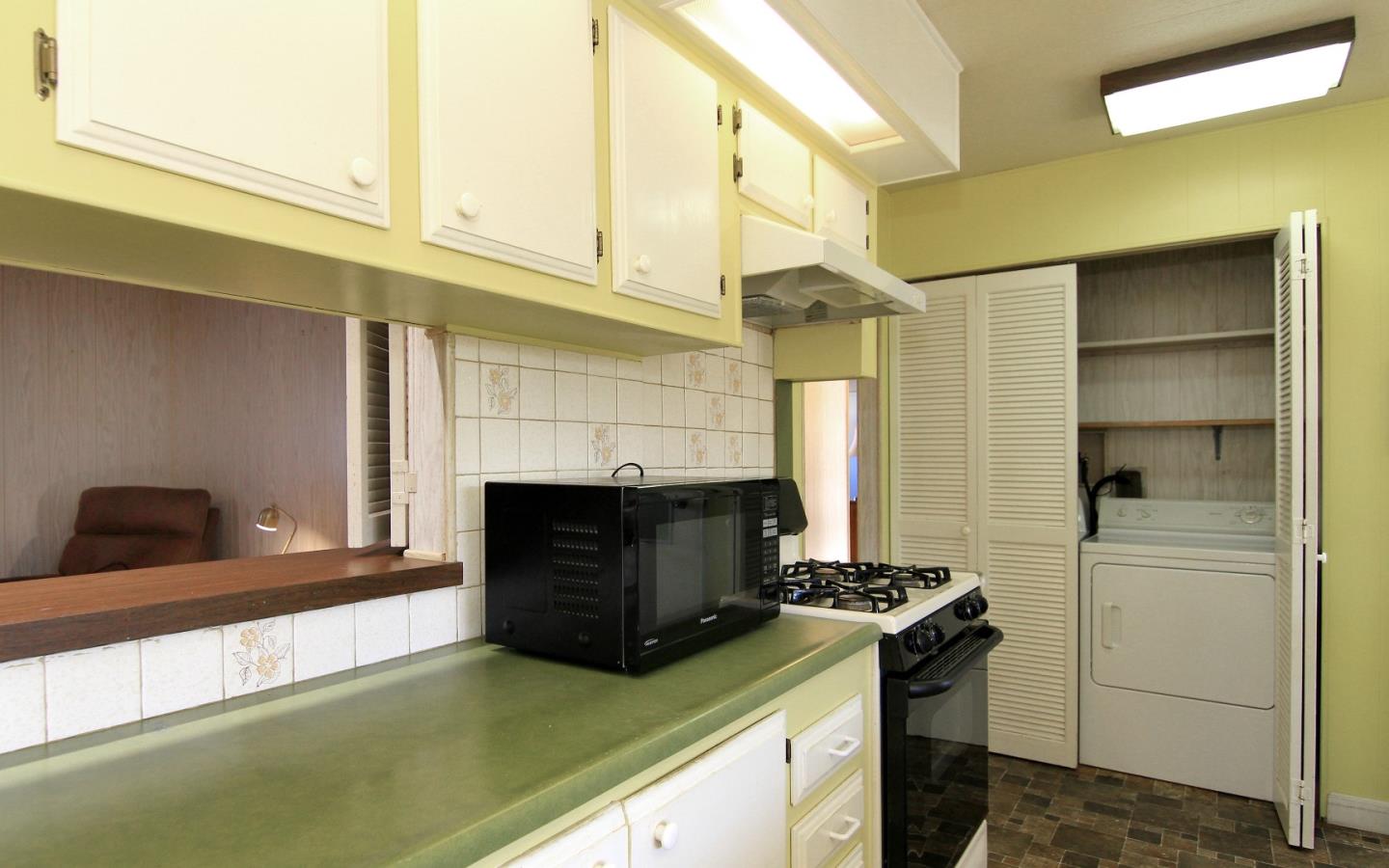 4425 Clares Street, Unit 3 Capitola, CA 95010 - Photo 11 of 23 a kitchen with stainless steel appliances granite countertop a stove and a refrigerator