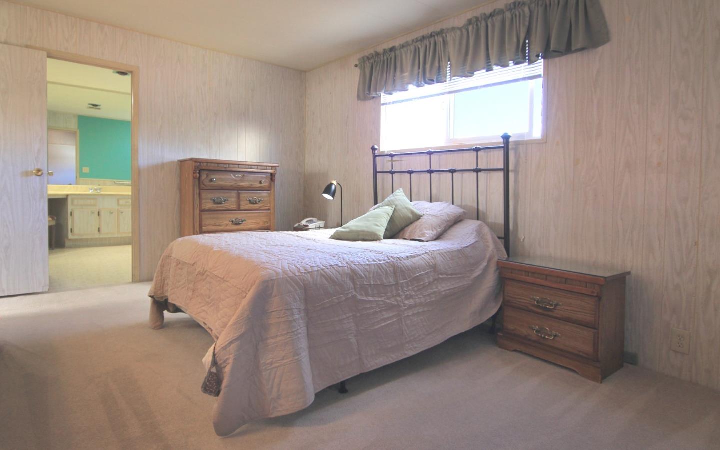 4425 Clares Street, Unit 3 Capitola, CA 95010 - Photo 14 of 23 a bedroom with a bed a dresser and a window