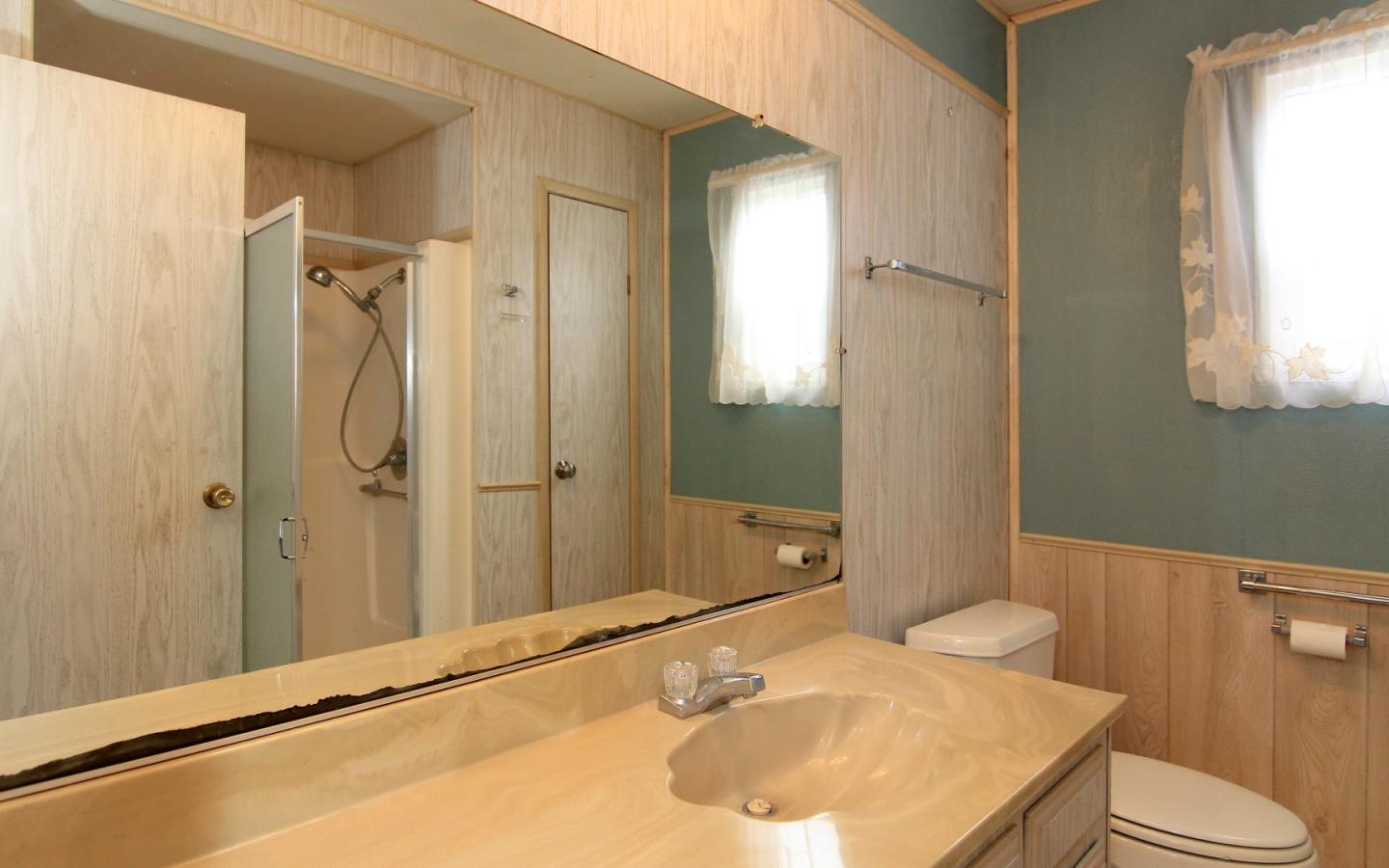 4425 Clares Street, Unit 3 Capitola, CA 95010 - Photo 18 of 23 a bathroom with a sink and mirror with toilet