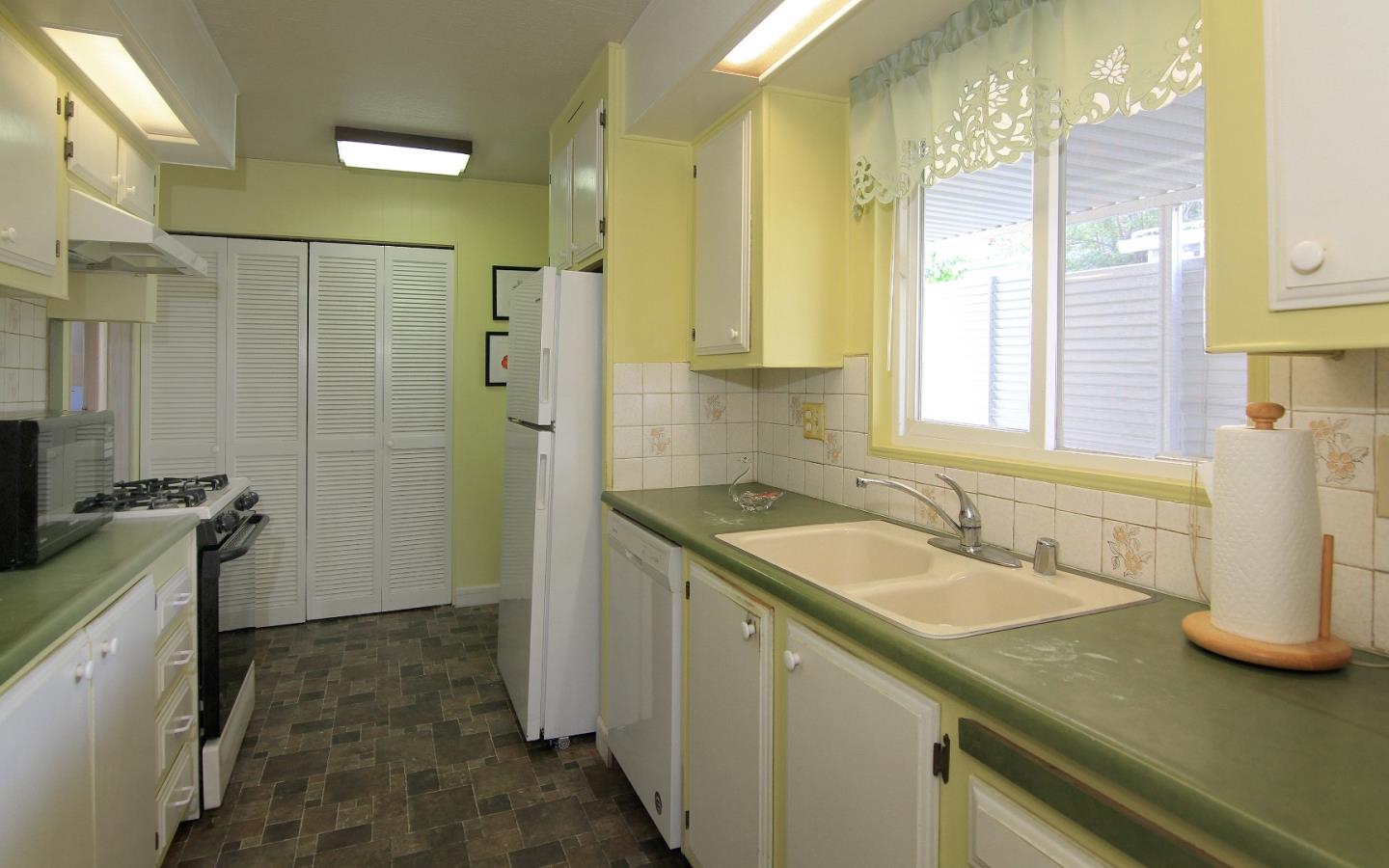 4425 Clares Street, Unit 3 Capitola, CA 95010 - Photo 9 of 23 a bathroom with a granite countertop sink a mirror and a shower