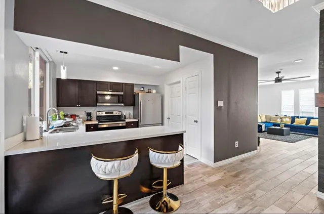 a kitchen with a sink stainless steel appliances and cabinets
