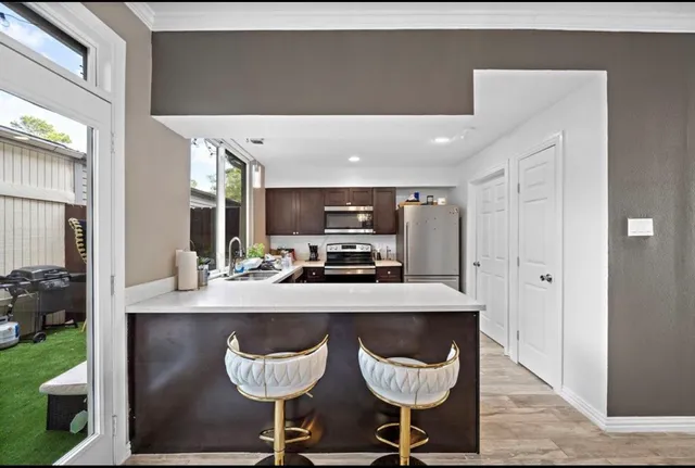 a kitchen with a table and chairs