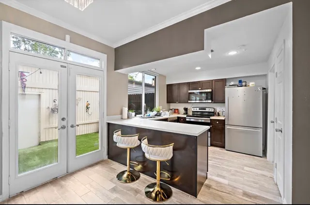 a kitchen with refrigerator cabinets and wooden floor