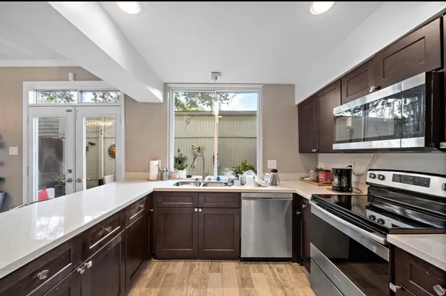 a kitchen with a sink stove and microwave