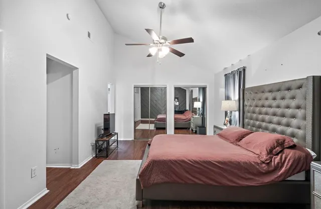 a bedroom with a large bed and a chandelier