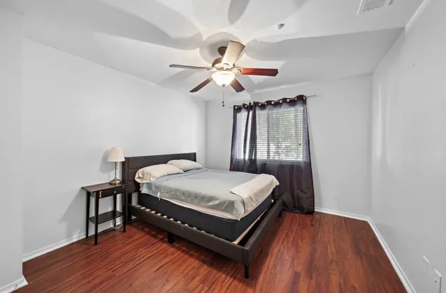 a bed sitting in a bedroom next to a window