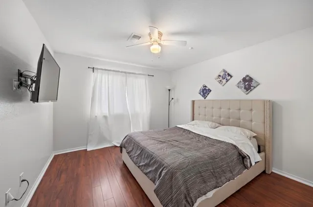a bedroom with a large bed and a chandelier