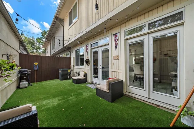 a view of a house with a yard and furniture