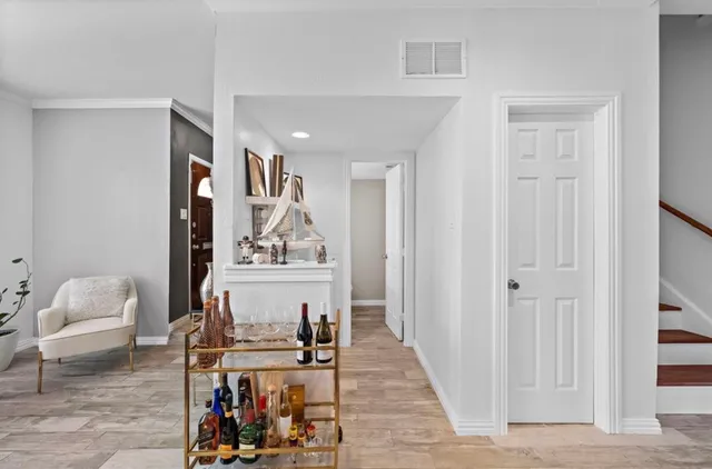 a view of a hallway with workspace and a window