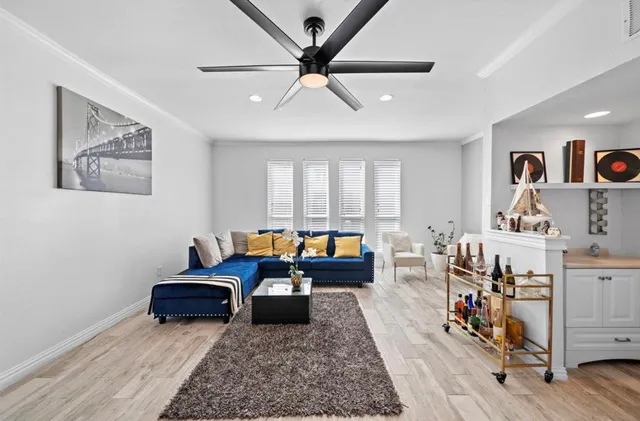 a living room with furniture and wooden floor