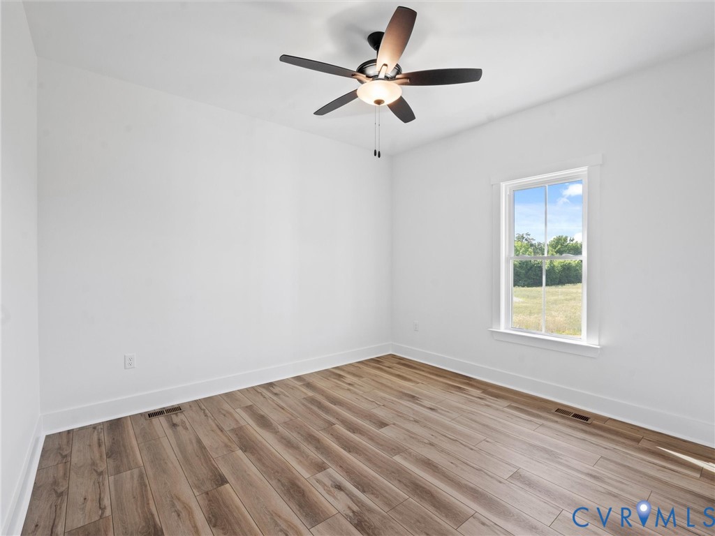 3289 Cumberland Road Cumberland, VA 23040 - Photo 22 of 29 an empty room with a window and a fan
