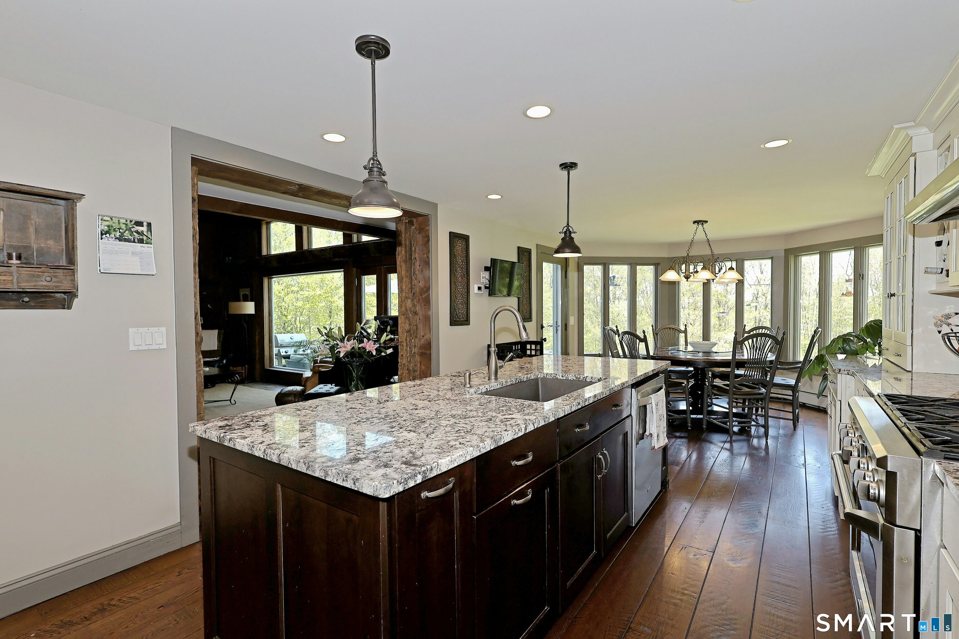 68 Bloomer Road Ridgefield, CT 06877 - Photo 12 of 40 a kitchen with granite countertop a stove a sink a dining table and chairs
