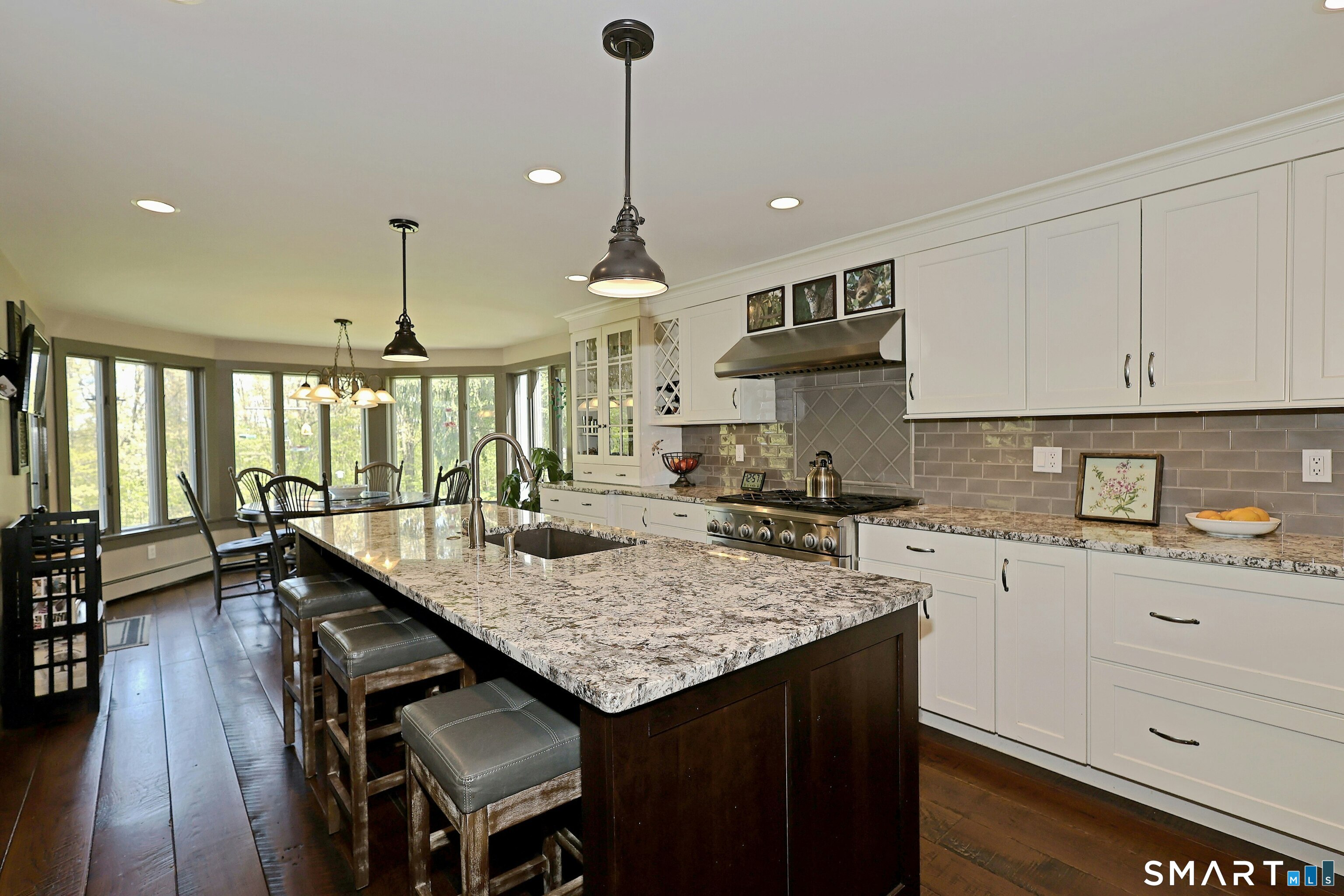 68 Bloomer Road Ridgefield, CT 06877 - Photo 14 of 40 a kitchen with granite countertop a stove a sink a dining table and chairs