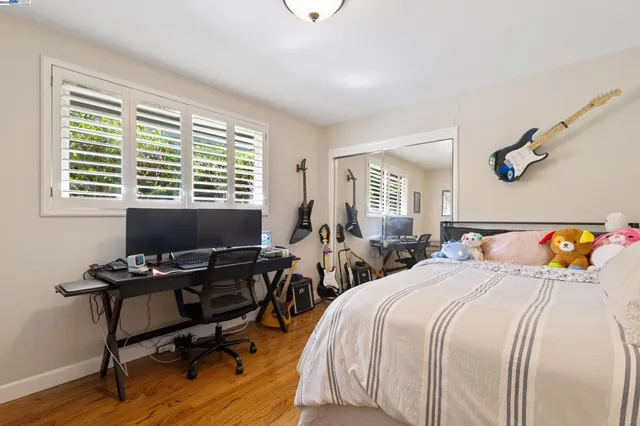 a bedroom with a bed a desk and chair