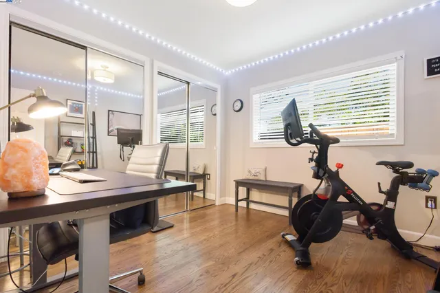 a room with lots of furniture and a wooden floor