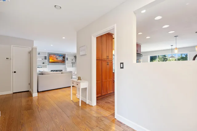 a view of a kitchen with wooden floor and electronic appliances