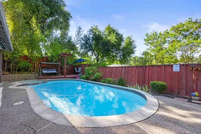 front view of a house with a swimming pool and a garden