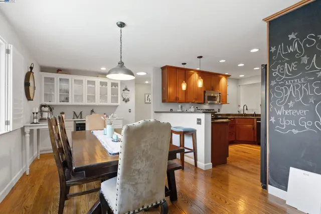 a view of a dining room with furniture and wooden floor
