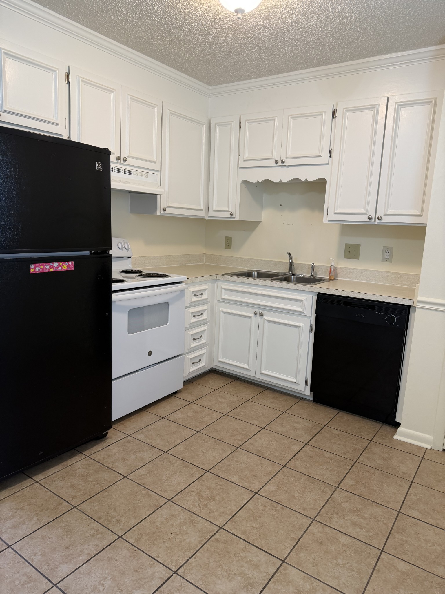 940 East Main Street Gallatin, TN 37066 - Photo 3 of 5 a kitchen with a cabinets and a refrigerator