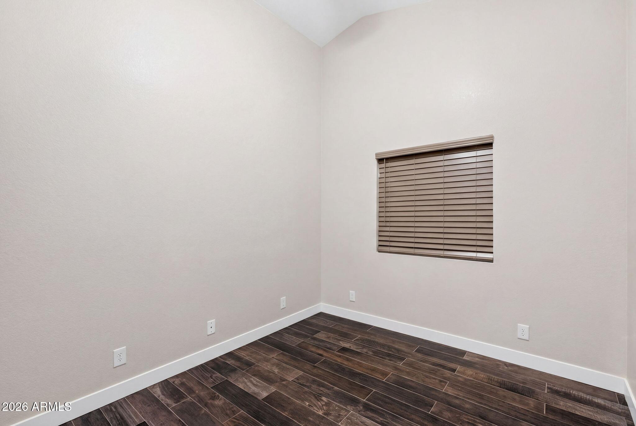 3242 North Ricardo Circle Mesa, AZ 85215 - Photo 41 of 79 a view of an empty room with wooden floor and a window