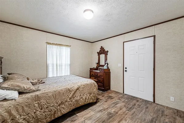 a bedroom with a bed and dresser