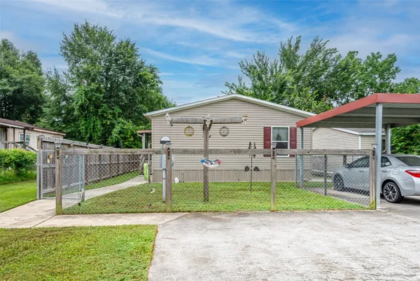 a view of a house with a yard and a garden