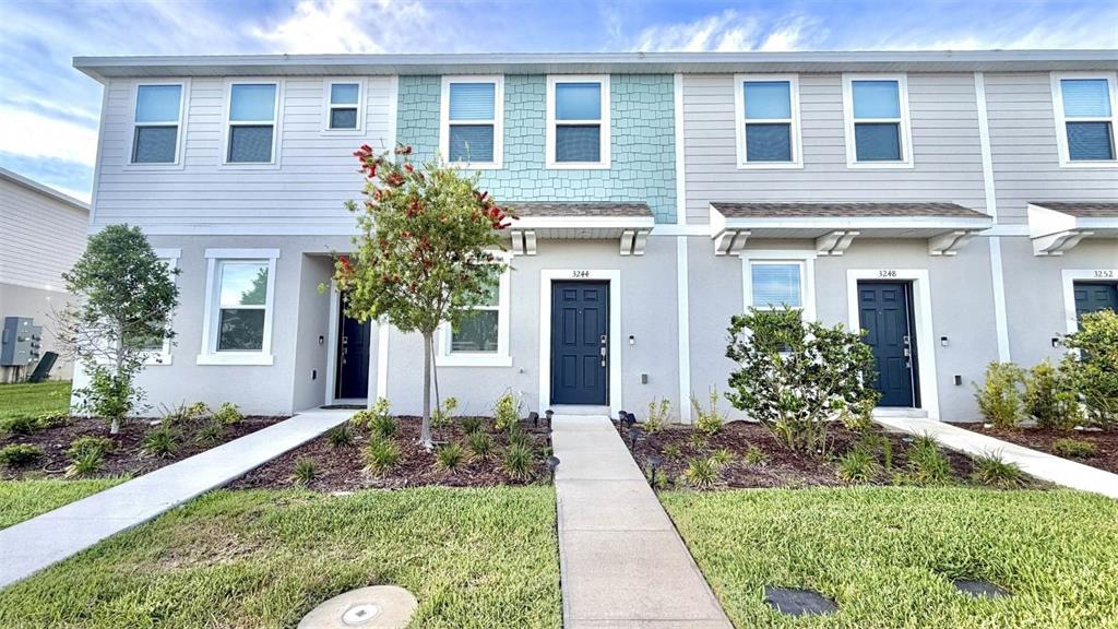 3244 Skyline Loop Kissimmee, FL 34758 - Photo 1 of 13 a front view of a house with a yard