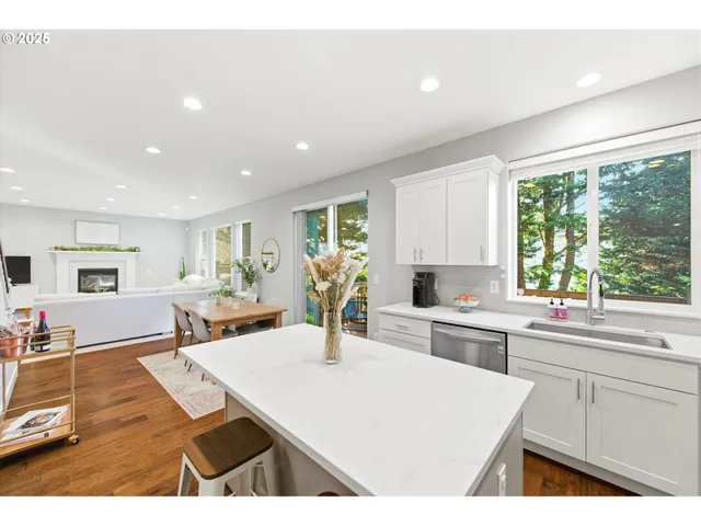 a kitchen with stainless steel appliances kitchen island granite countertop a sink and cabinets