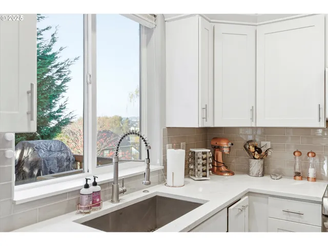 a kitchen with a sink and a refrigerator