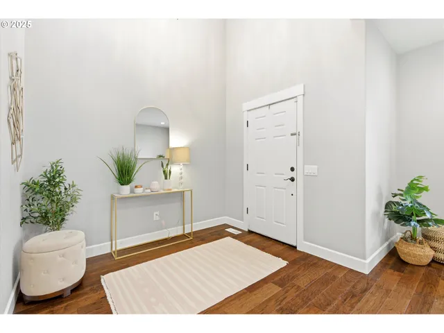 a living room with a potted plant and a table
