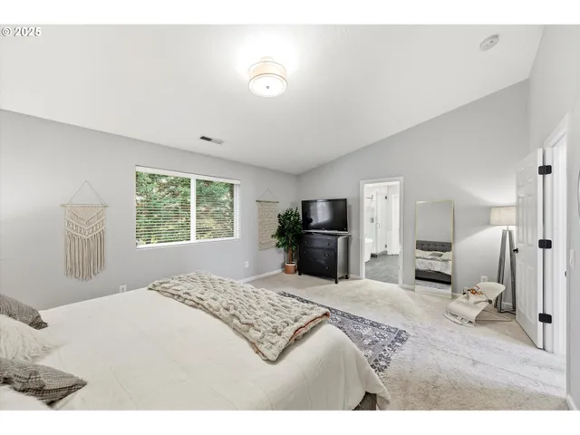 a bedroom with a bed and a television