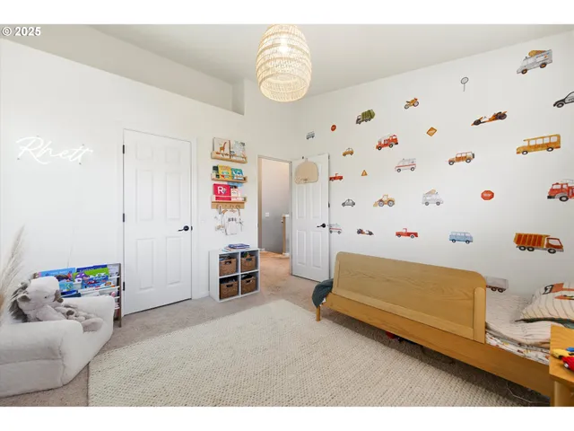 a bedroom with baby toys and wooden floor