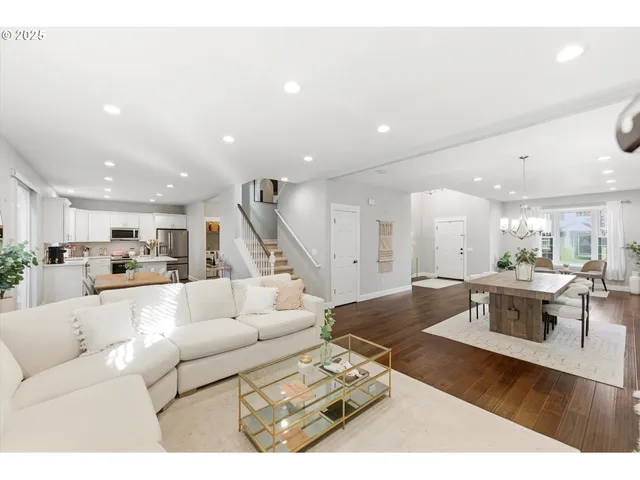 a living room with furniture wooden floor and a table