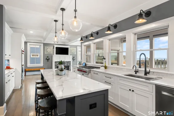 a kitchen with stainless steel appliances granite countertop a sink and a stove