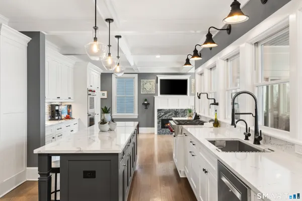 a kitchen with white cabinets and white appliances