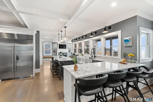 a kitchen with stainless steel appliances kitchen island granite countertop a sink and cabinets