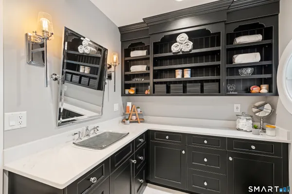 a bathroom with a granite countertop sink a mirror a vanity and bathtub