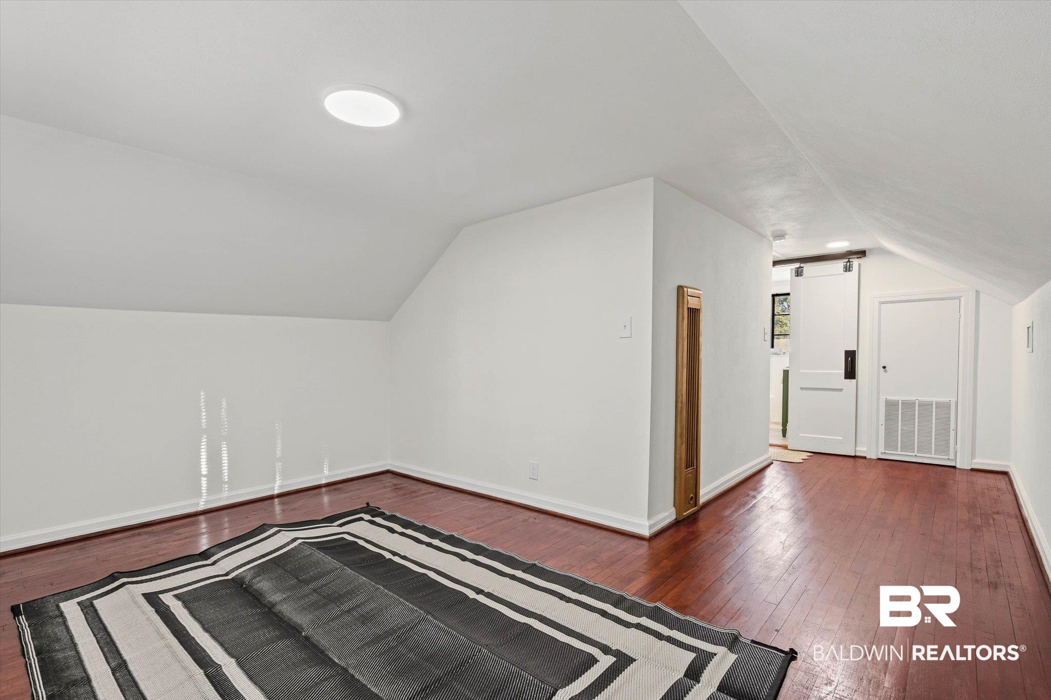 2806 Exter Drive Mobile, AL 36606 - Photo 15 of 24 Additional living space featuring dark wood finished floors and vaulted ceiling