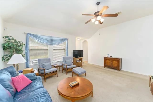 a living room with furniture or couch and a potted plant