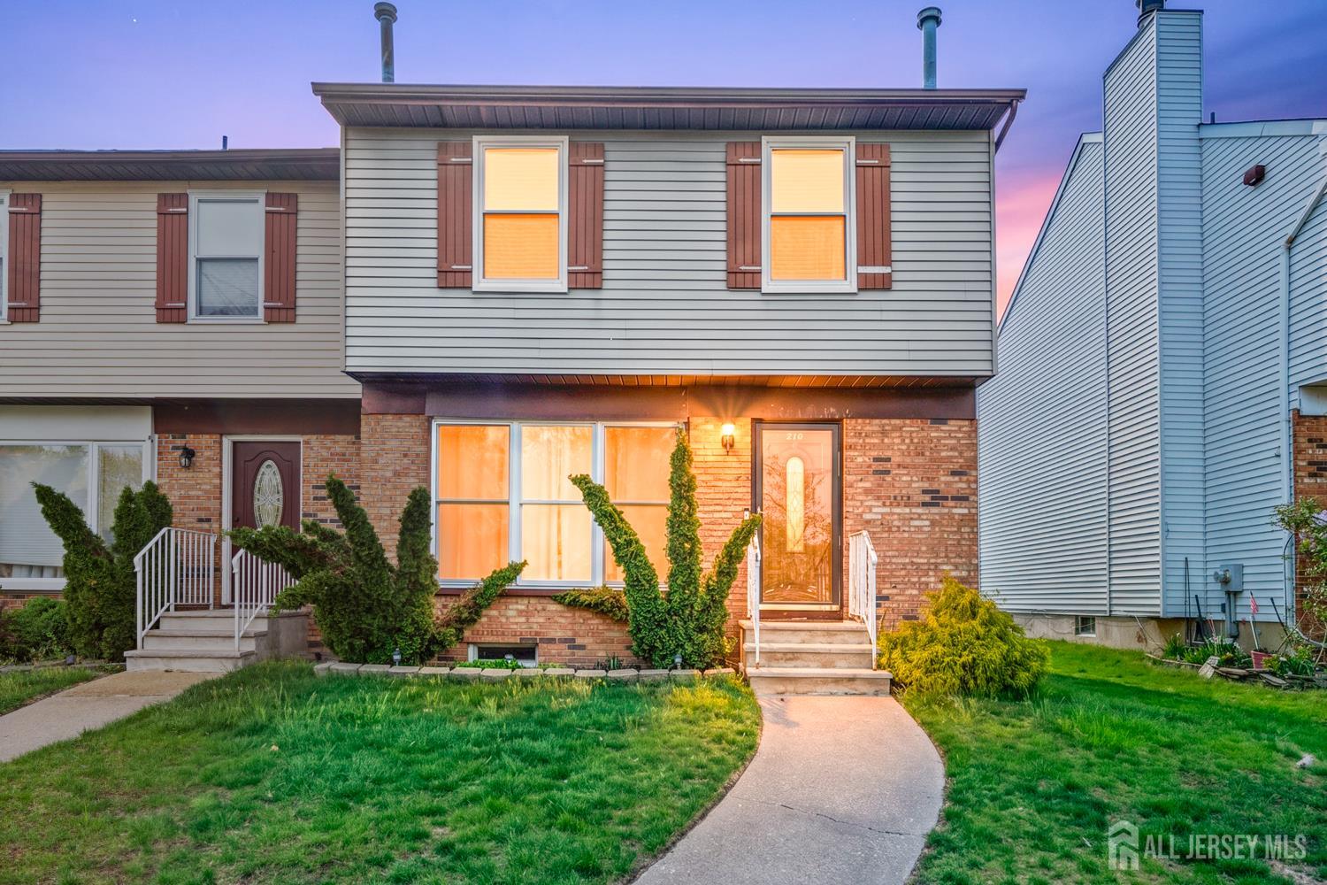 a front view of a house with garden