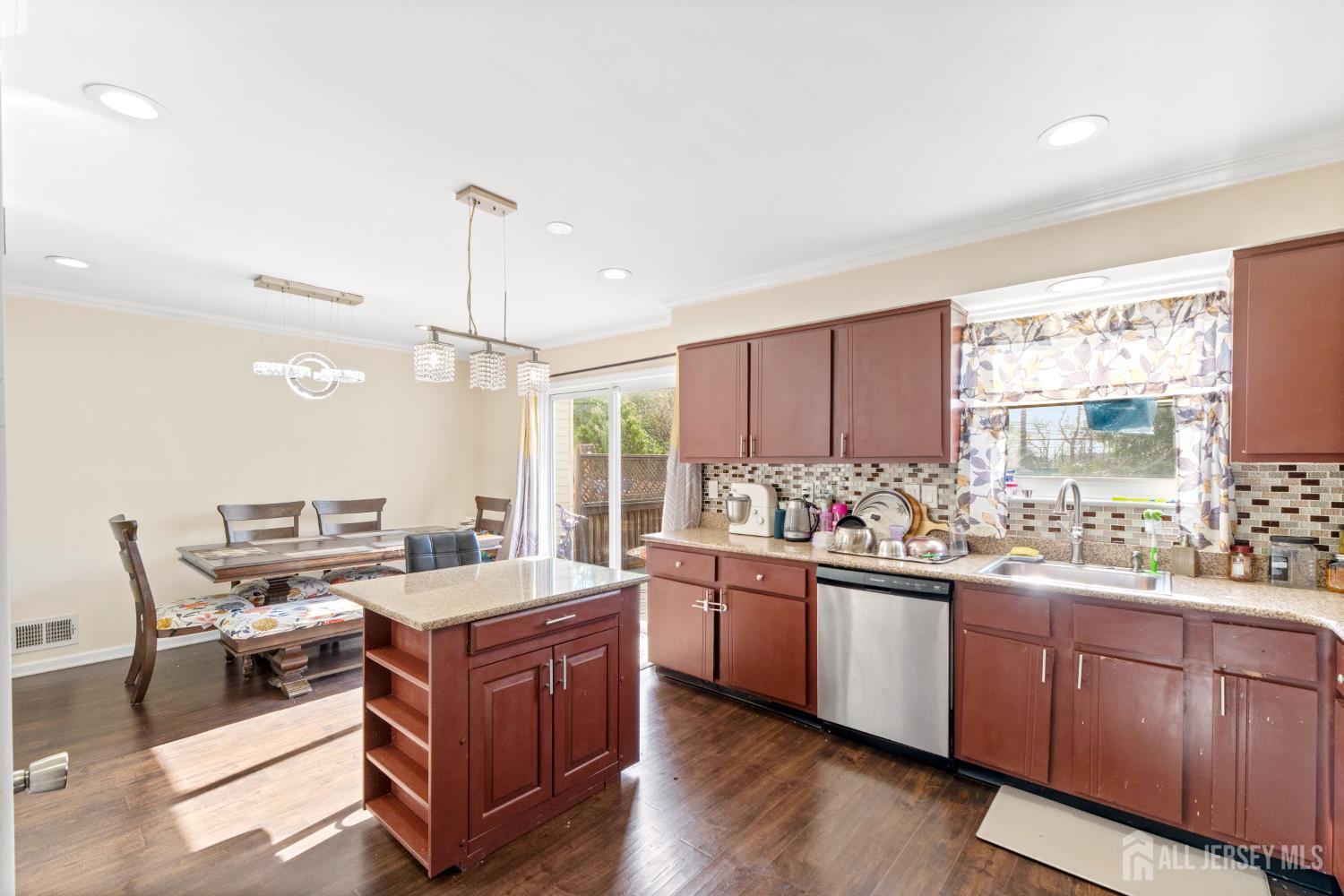 114 Pendleton Place Old Bridge, NJ 08857 - Photo 16 of 49 a kitchen with a stove a sink and a wooden cabinets