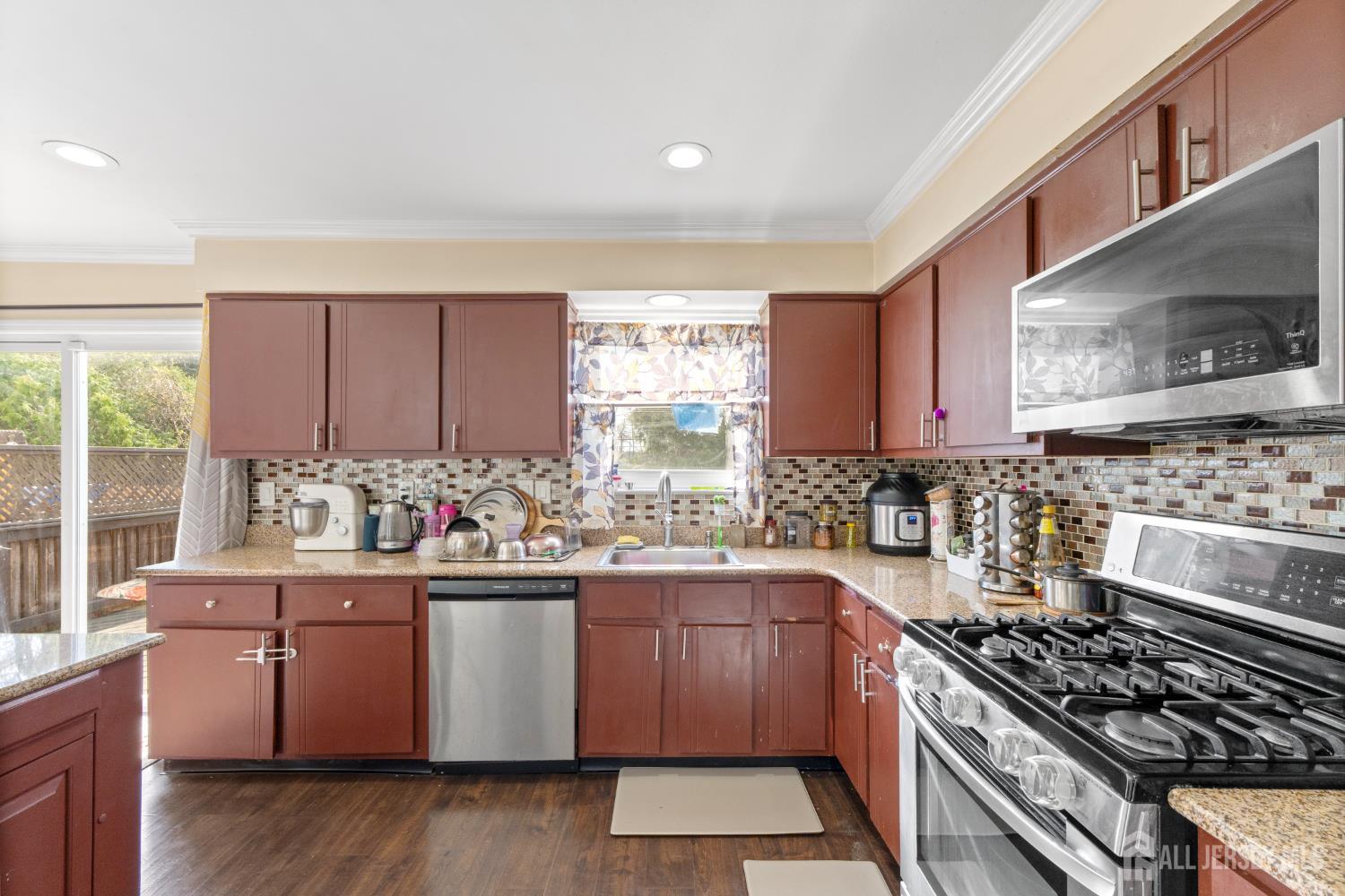 114 Pendleton Place Old Bridge, NJ 08857 - Photo 19 of 49 a kitchen with stainless steel appliances a stove a sink and a microwave