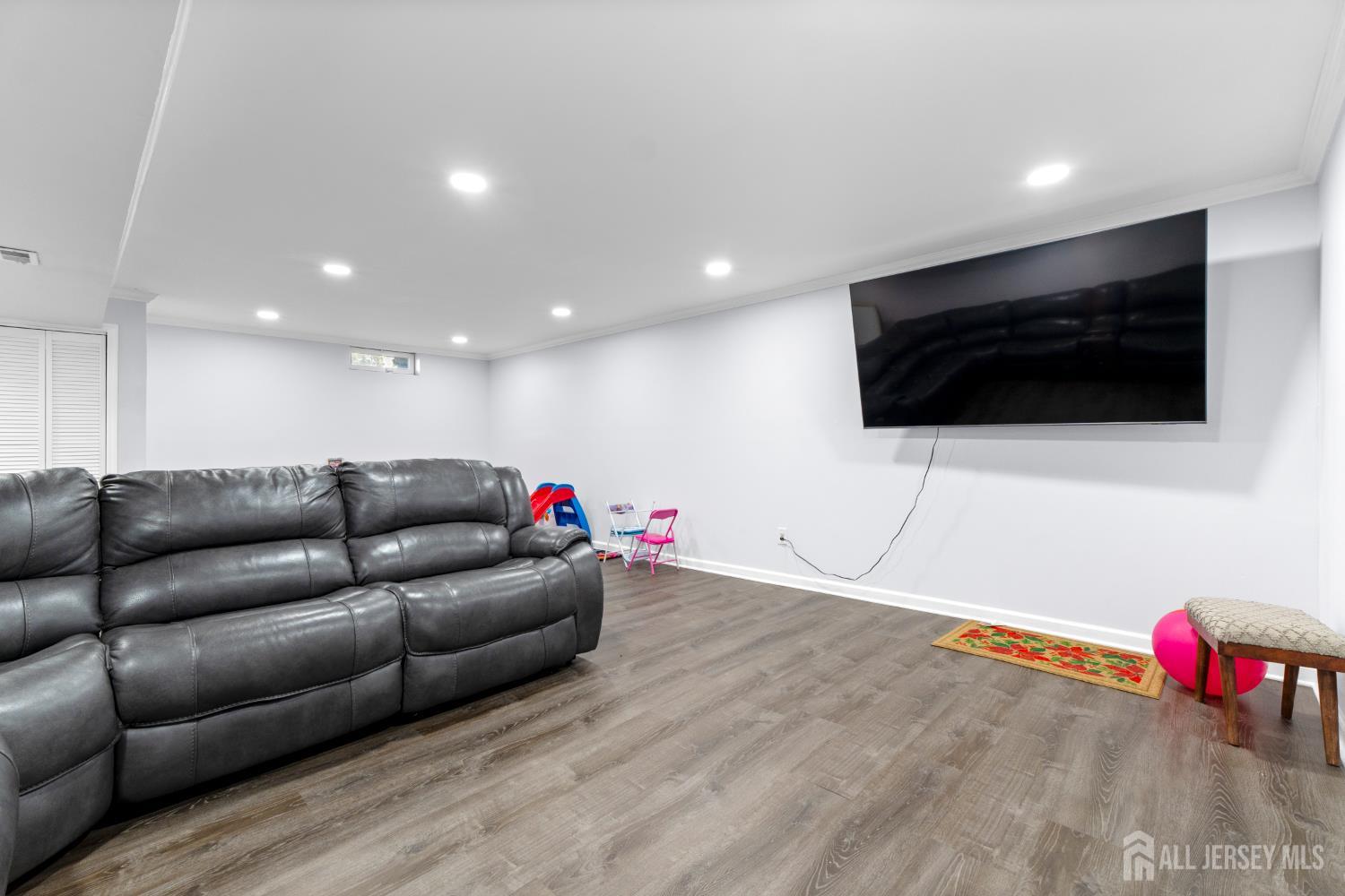 114 Pendleton Place Old Bridge, NJ 08857 - Photo 24 of 49 a living room with furniture and a flat screen tv